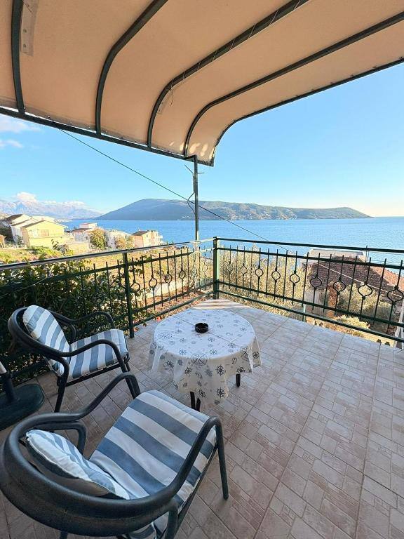 Private balcony with table and chairs overlooking the bay