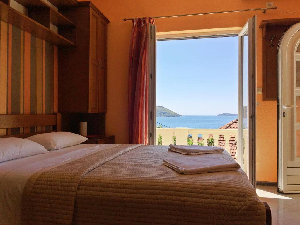 Bedroom with open balcony door and sea view